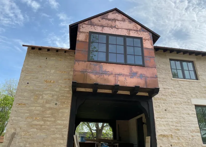 Copper metal panel facade on a stone building for Skylight Installation in Ridgecrest