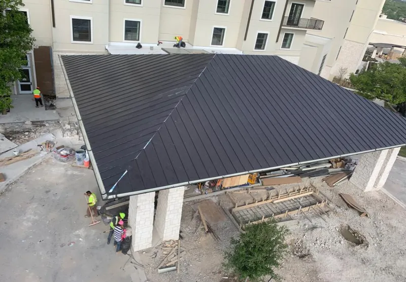 Metal roofing installation team working on a commercial building in Ridgecrest